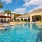 Large pool with shaded seating and clubhouse access.