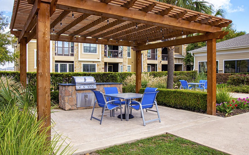 Pergola with grills and small table seating