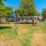 large, fenced in dog park with play equipment