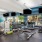 ceiling fans and lighting throughout large fitness center with various cardio and strength training equipment