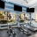cardio machines in look out through picture windows with wall mounted tv screens above