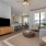 spacious living room with a ceiling fan and a light fixture at retreat at chelsea park apartments