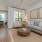 window brightens open living room next to kitchen counter with stools