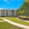 tidy lawns and walkways across apartment grounds with large, tree shaded hammock garden and grilling area