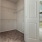 well lit walk-in closet with built-in shelving